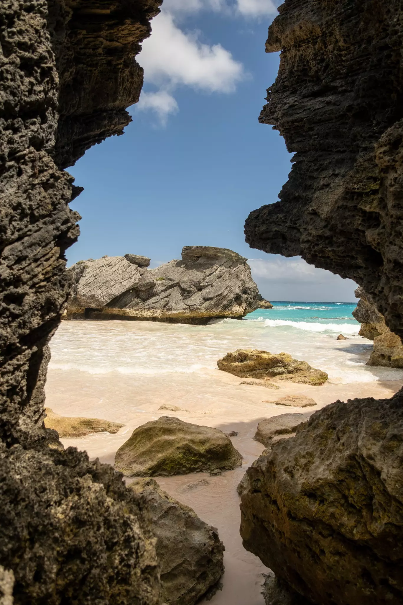 A sandy beach surrounded by rocks