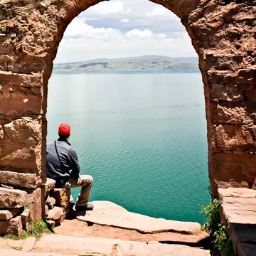 Man sits under a stone archway on Taquile Island.
111711794
top, sky, sea, peru, isla, arch, town, hike, gate, trek, lake, walk, blue, inca, path, puno, trail, latin, south, sunny, island, travel, scenic, outdoor, america, typical, culture, holiday, scenery, village, country, taquile, walkway, highland, amantani, titicaca, solitude, postcard, panorama, mountain, peruvian, tranquil, vacation, beautiful, landscape, destination, traditional, architecture
