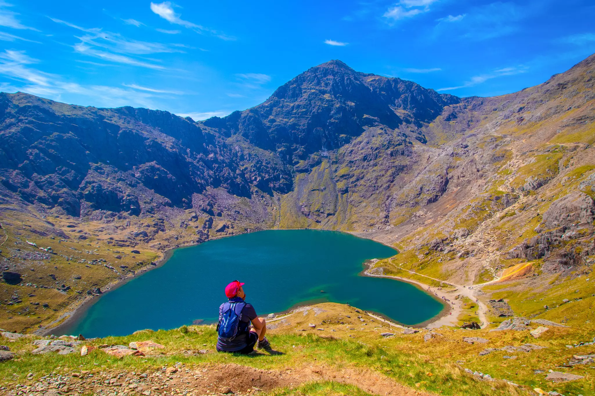 People Hiking and looking across the Snowdon Horseshoe at Yr Wyddfa (Mt Snowdon).
