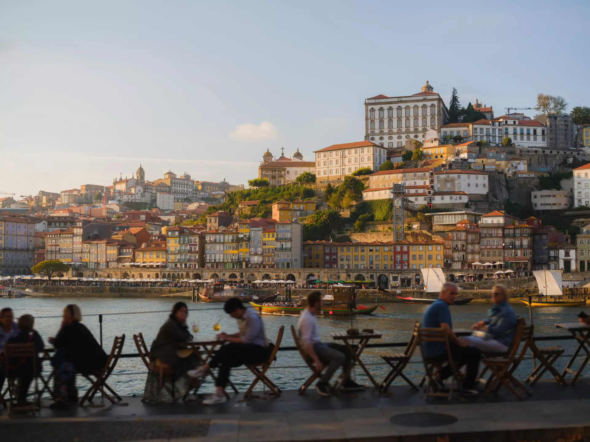 people sitting out on a patio at a restaurant in Porto, Portugal. 