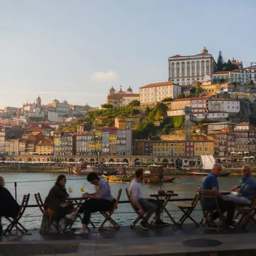 people sitting out on a patio at a restaurant in Porto, Portugal. 