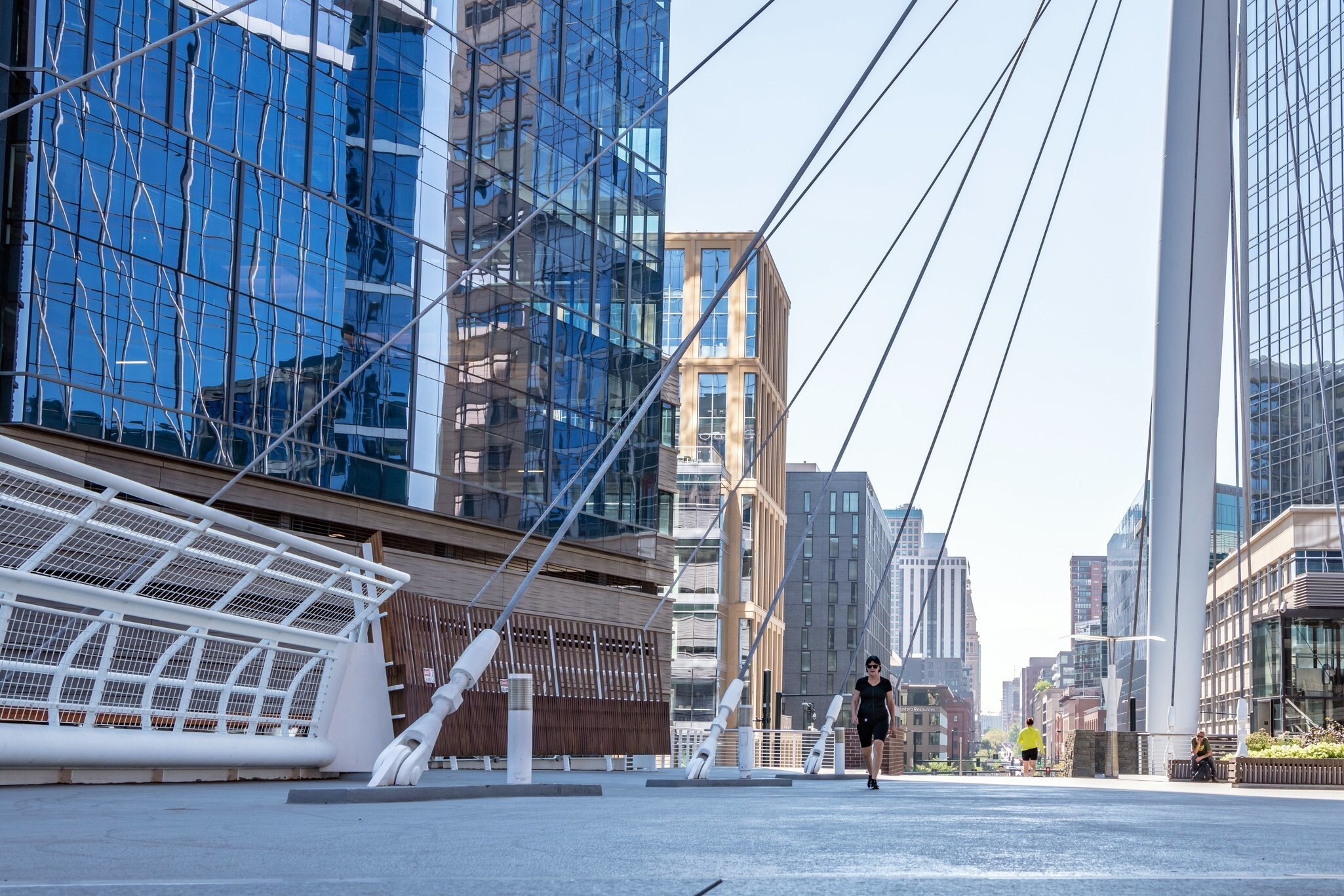 Denver, Colorado - August 28, 2021: People cross the Millennium Bridge on 16th street downtown, in the LoDo (Lower Downtown) neighborhood.