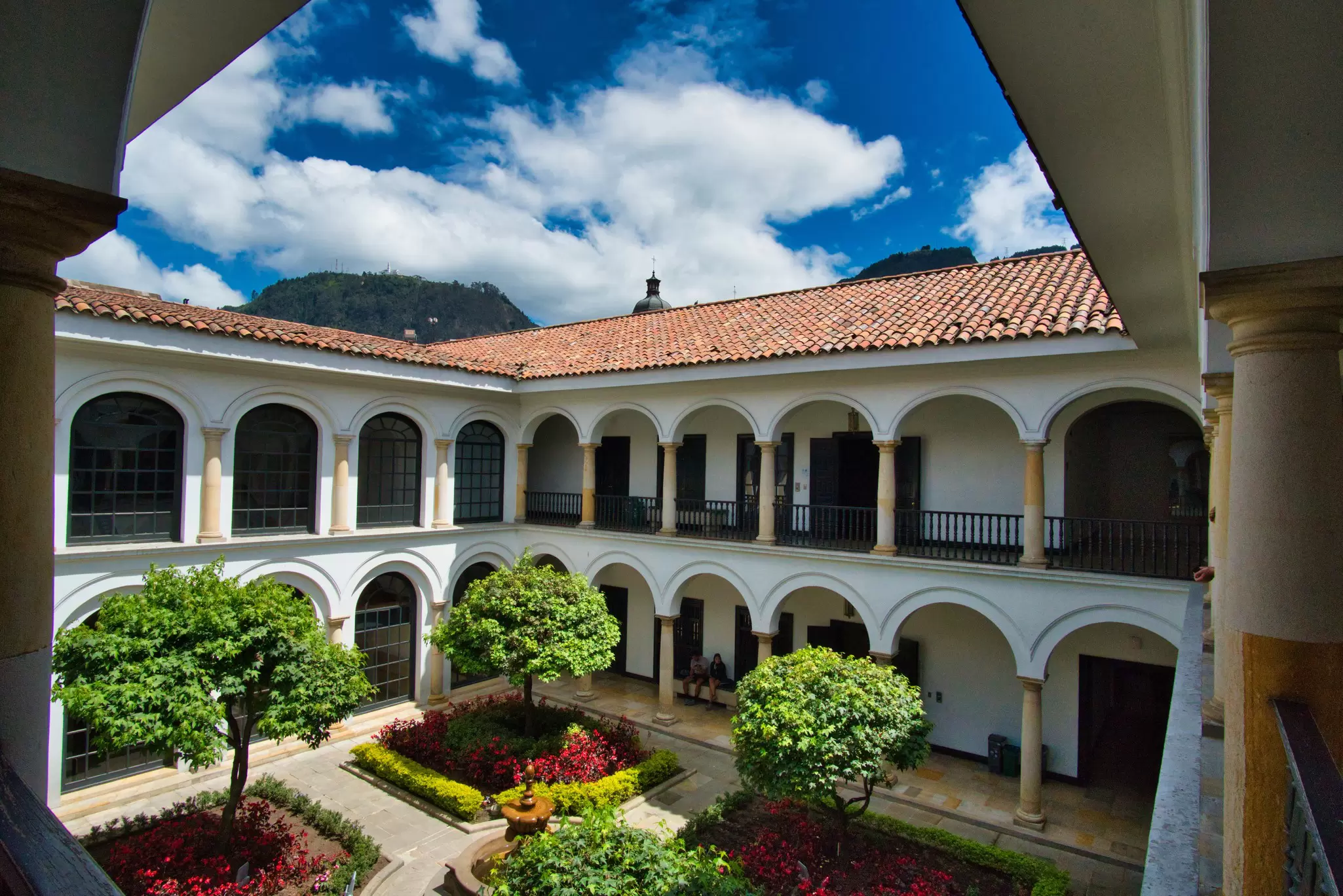 Interior garden of Museo Botero with a view of Monserrate in the background, on a cloudy day in Colombia.