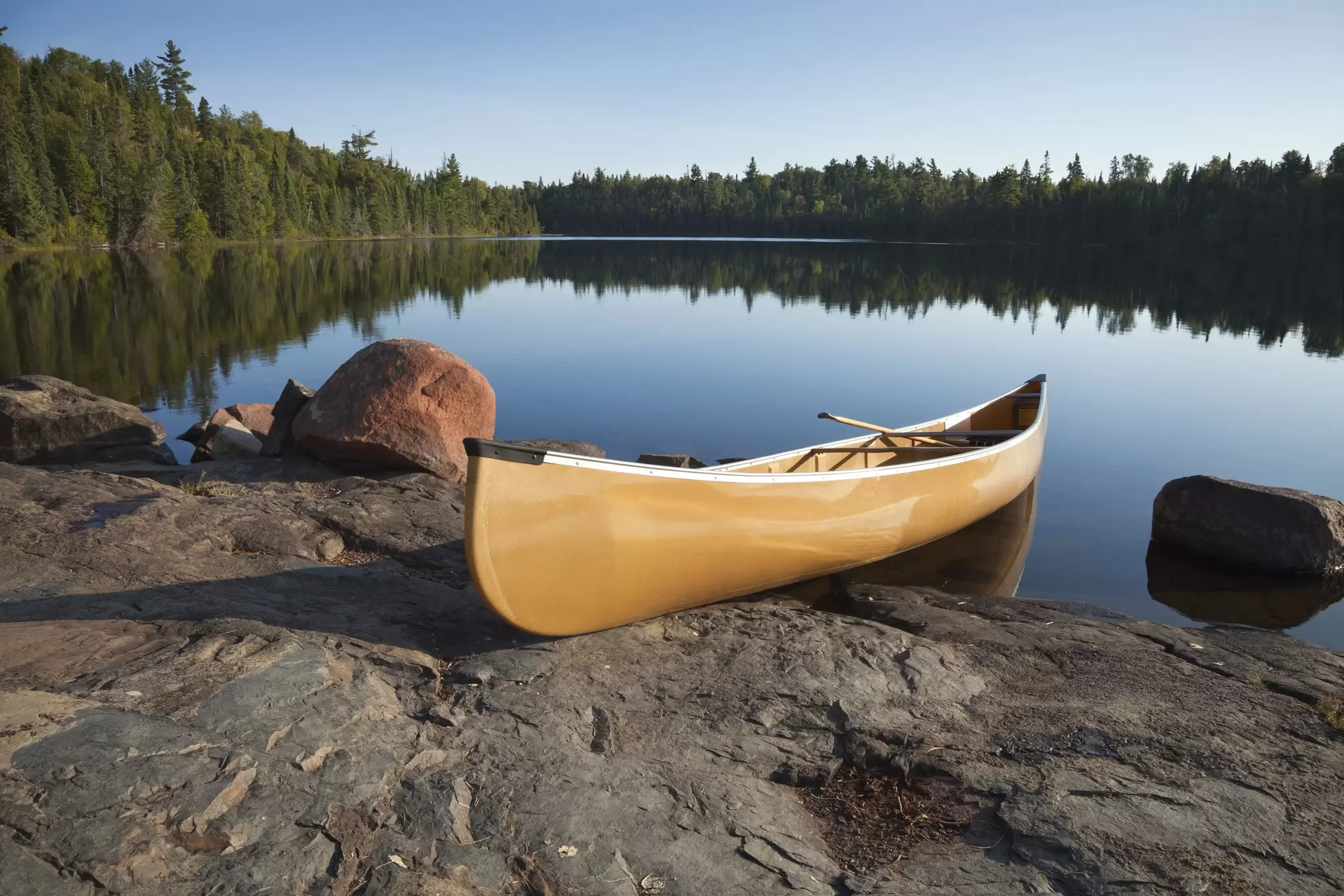 A canoe waiting by a calm lake at Boundary Waters, Minnesota. 