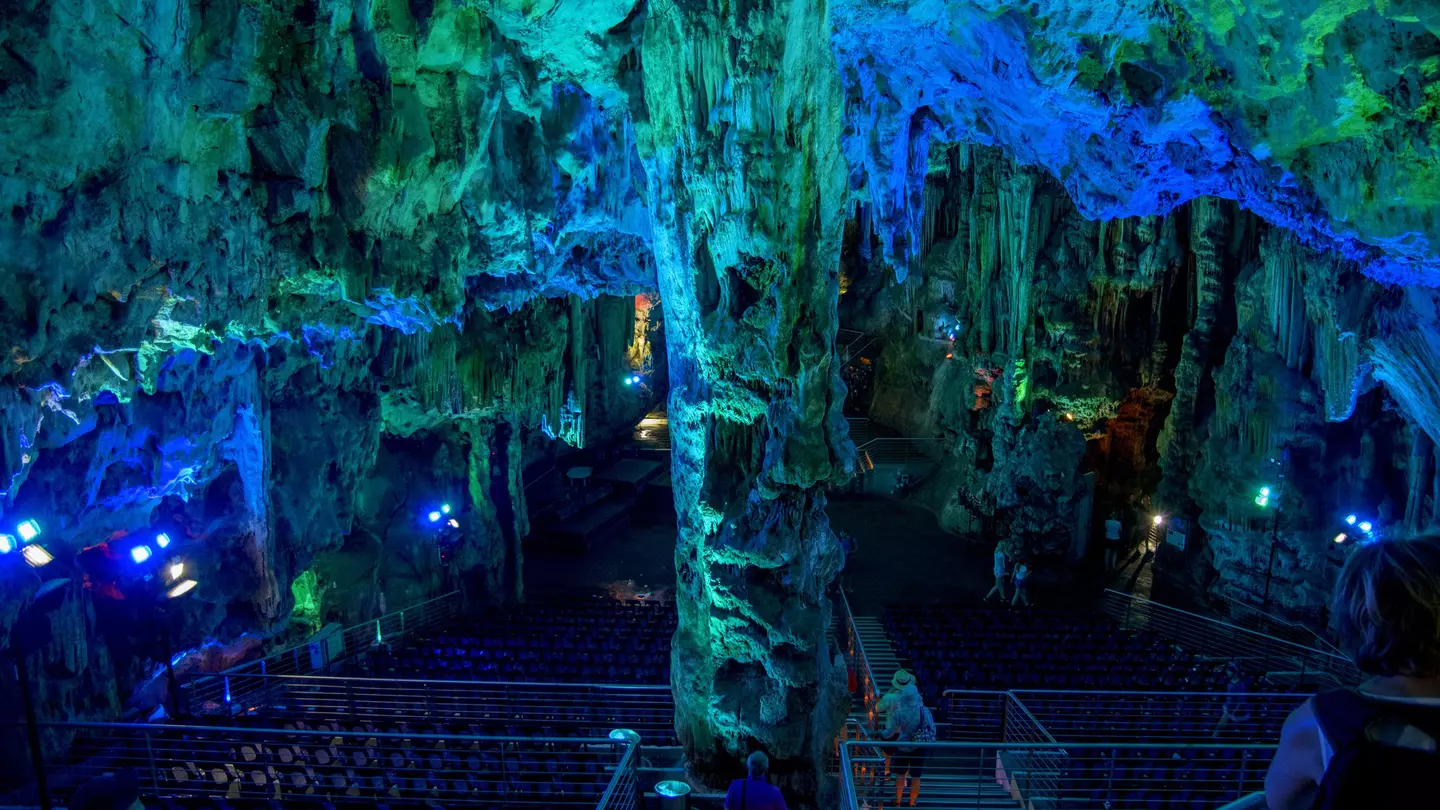 A cave enhanced with light that makes its ceilings blue and green