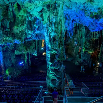A cave enhanced with light that makes its ceilings blue and green