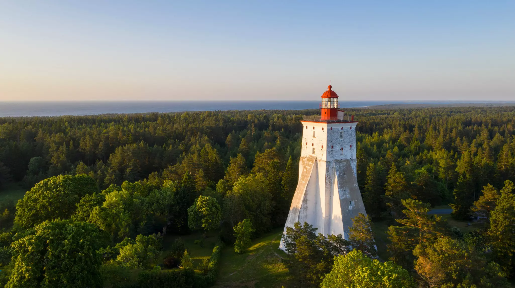 Aerial view on a historic lighthouse in a forest.