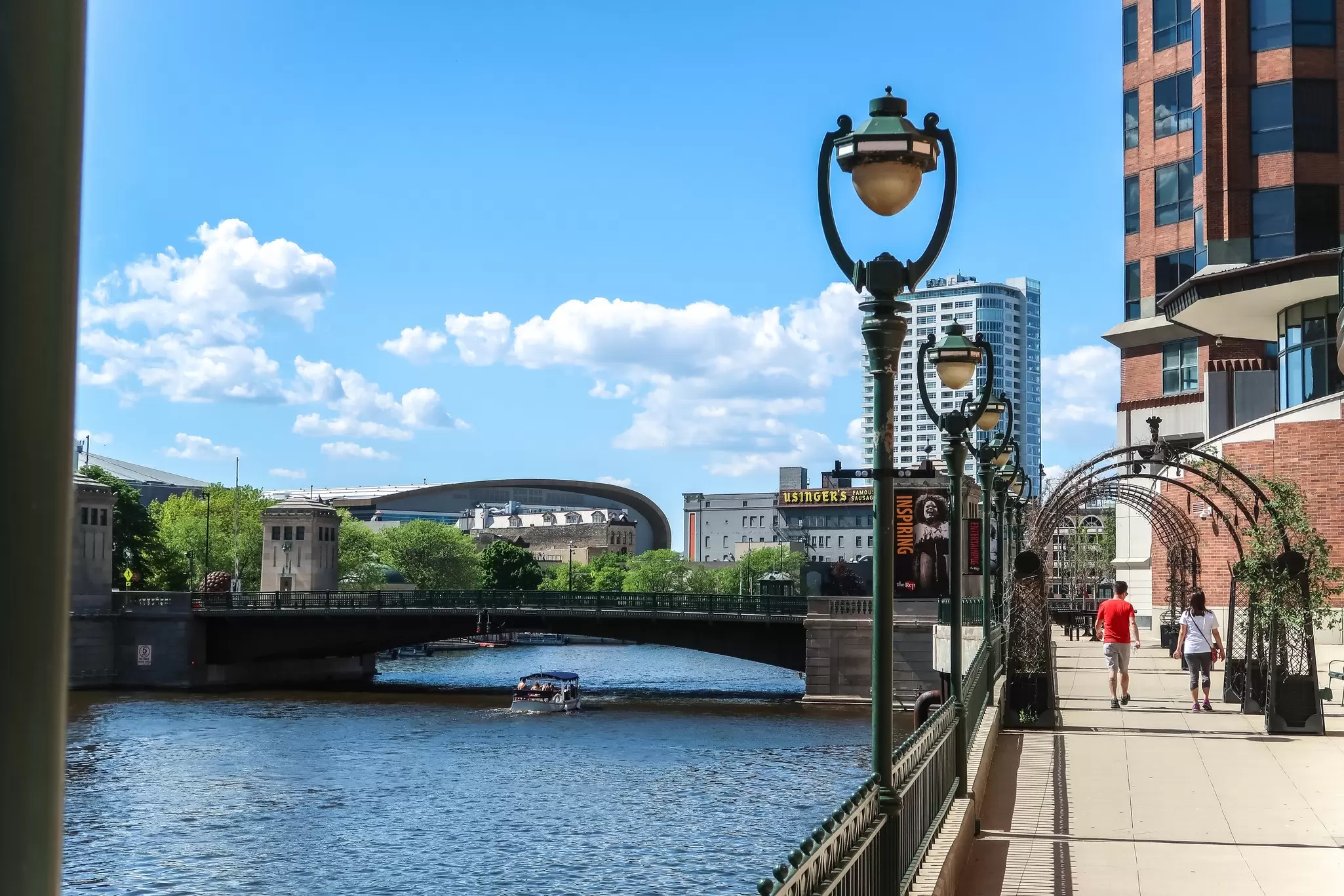 Milwaukee, Wisconsin - May 26th, 2018: The new Milwaukee Bucks Fiserv Forum multi-purpose basketball arena's curved roof rises above nearby buildings adjacent to the Milwaukee River in downtown., License Type: media, Download Time: 2025-08-22T14:41:20.000Z, User: mvm_lonelyplanet, Editorial: true, purchase_order: 56530 - Guidebooks, job: Eastern USA 7, client: Global Publishing-WIP, other: Virginia Moreno