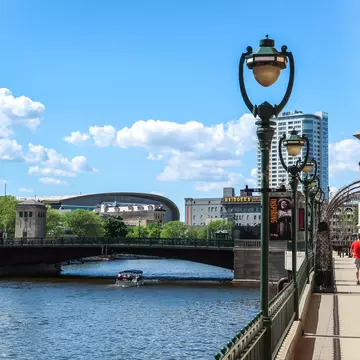 Milwaukee, Wisconsin - May 26th, 2018: The new Milwaukee Bucks Fiserv Forum multi-purpose basketball arena's curved roof rises above nearby buildings adjacent to the Milwaukee River in downtown., License Type: media, Download Time: 2025-08-22T14:41:20.000Z, User: mvm_lonelyplanet, Editorial: true, purchase_order: 56530 - Guidebooks, job: Eastern USA 7, client: Global Publishing-WIP, other: Virginia Moreno