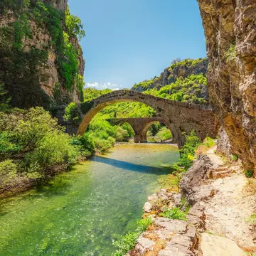 Kokkorou bridge, medieval stone bridge on river of Voidomatis, Pindus Mountains, Zagori, Greece. zedspider / Shutterstock
