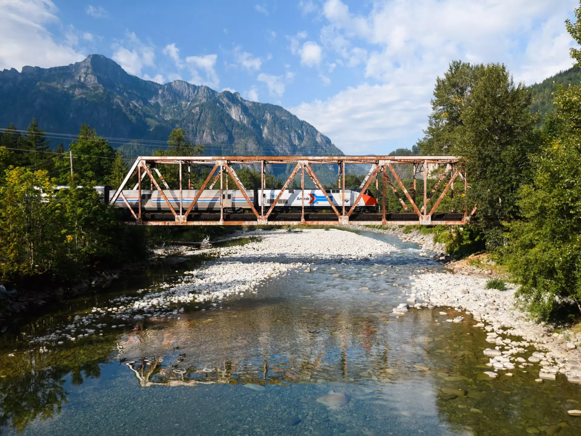 The Empire Builder train crossing the North Fork Skykomish River, Washington. Ian Dewar Photography/Shutterstock