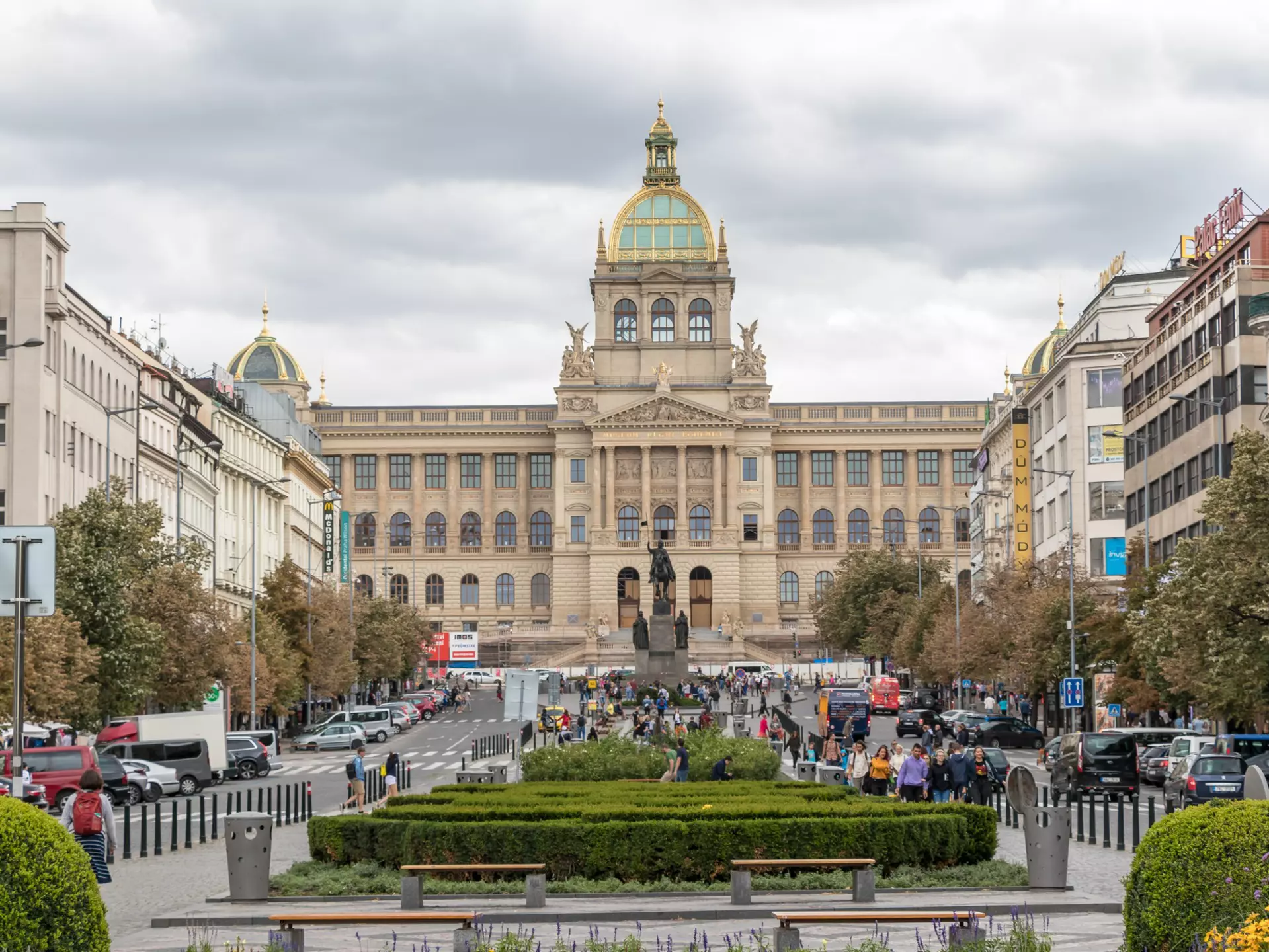 A large museum building at one end of a city square.
