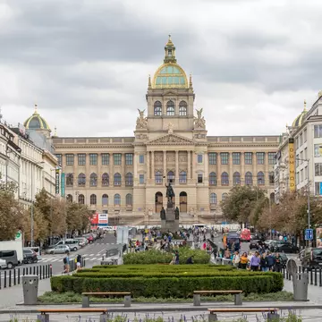 A large museum building at one end of a city square.