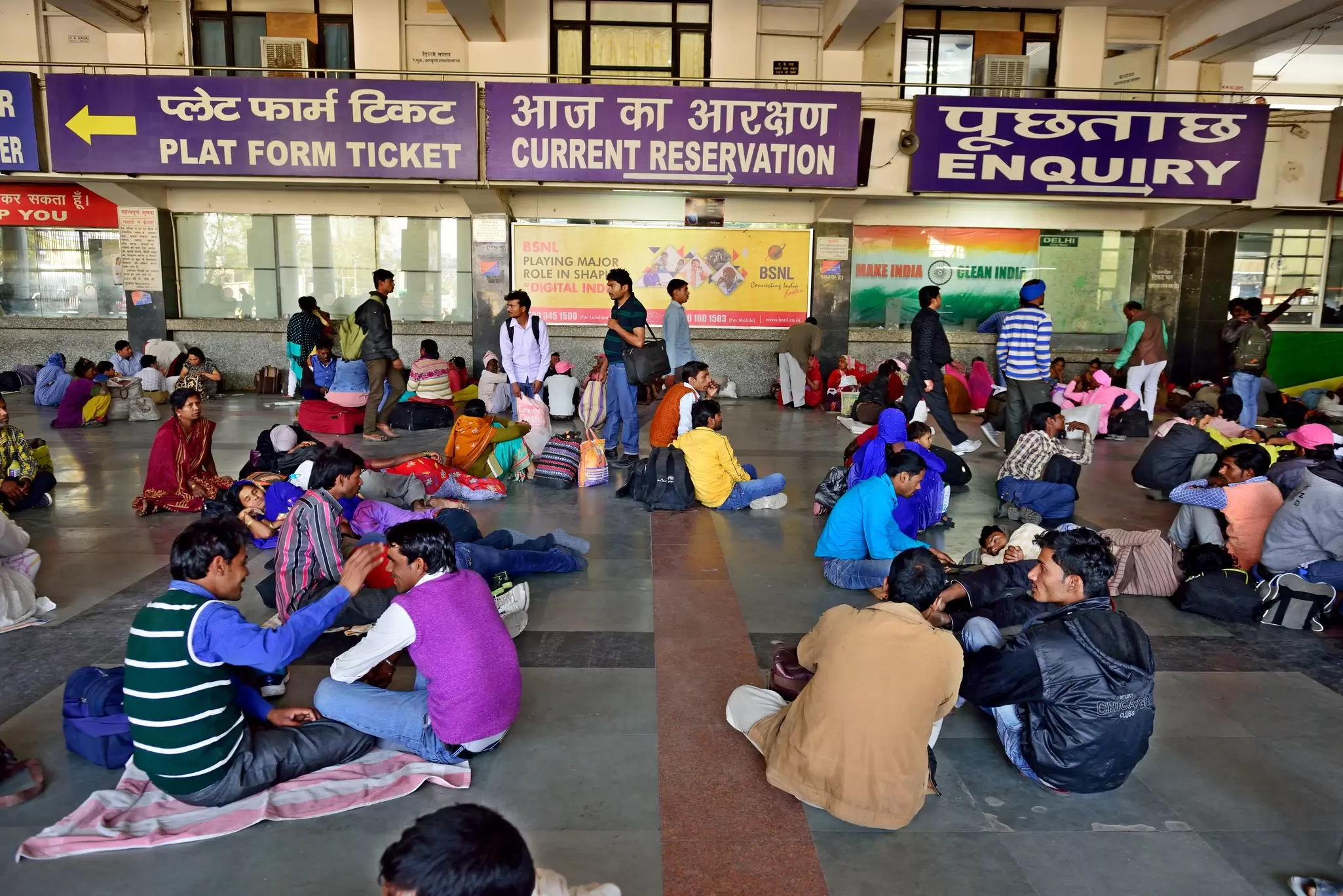 Passengers waiting at New Delhi Railway Station, India.