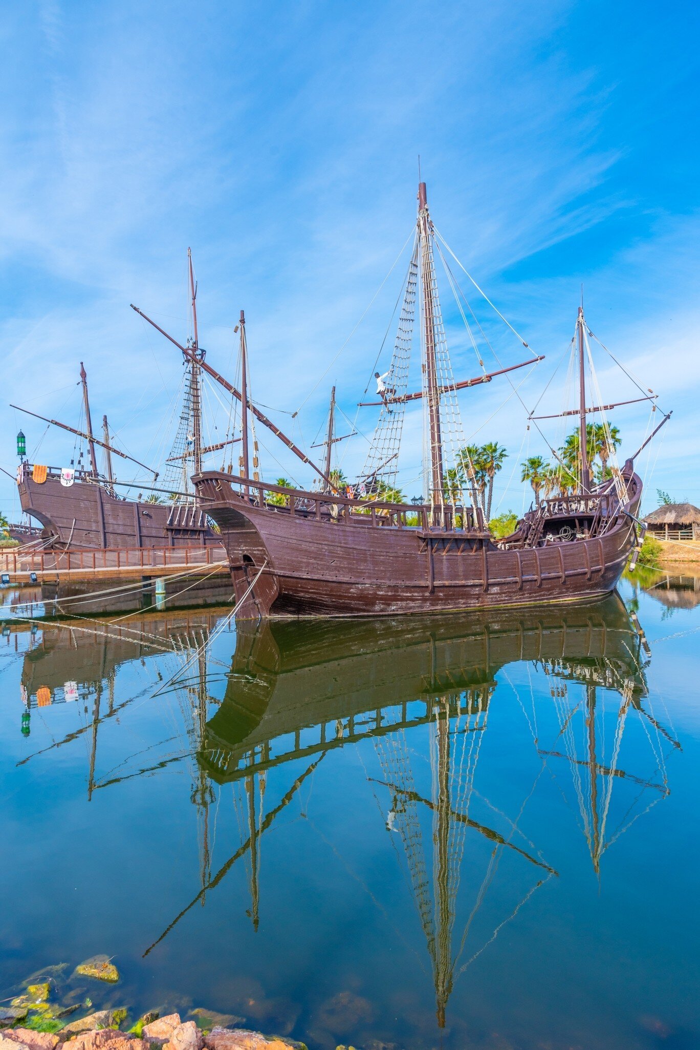 View of the replicas of Columbus' ships, Niña, Pinta and Santa María in the water at Muelle de las Carabelas in Spain.