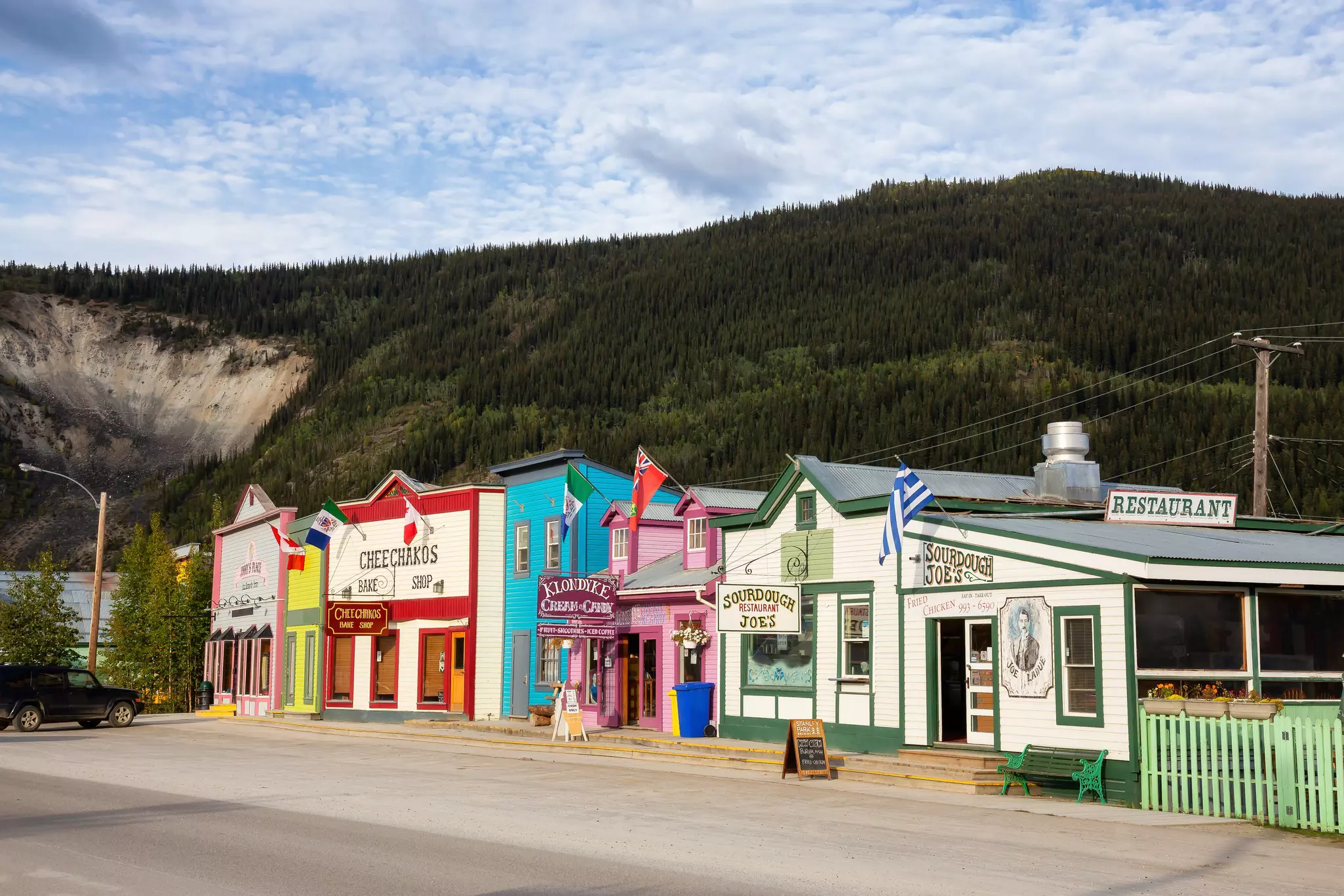 Colorful historic buildings against a mountain backdrop in Dawson City, Yukon, Canada