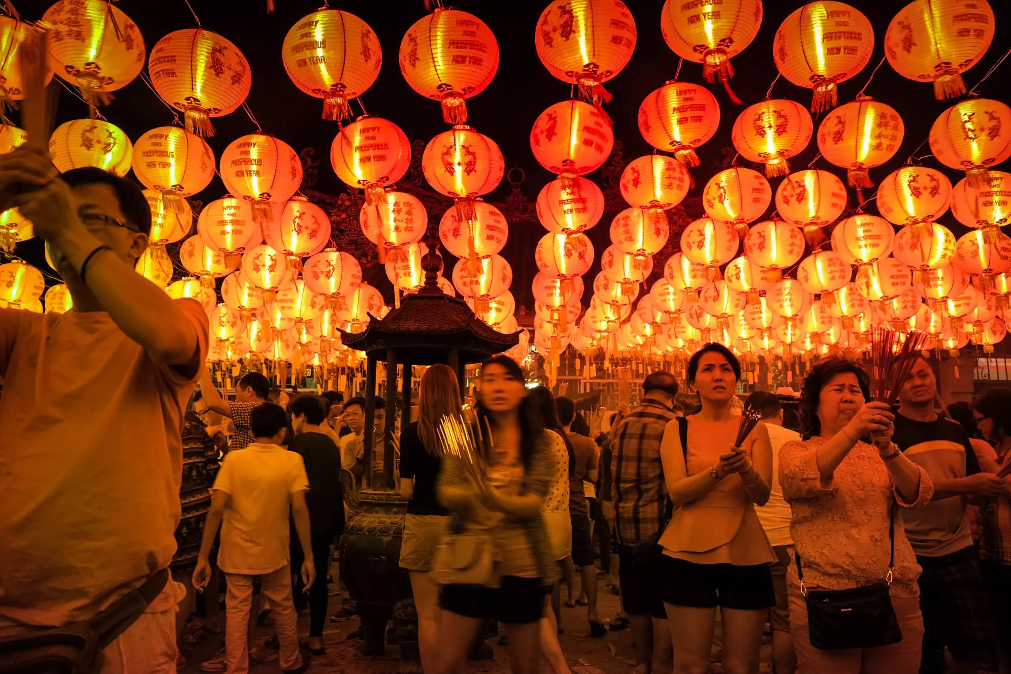 Devotees light joss sticks for Goddess of Mercy Kwan Yin at her shrine on Penang Island © Kit Yeng Chan / Lonely Planet