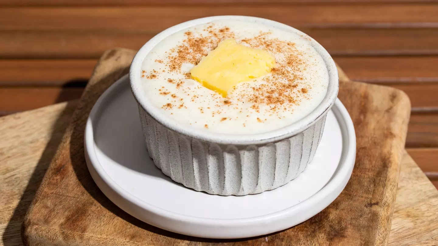 Close up of Risengrod bowl  with butter and cinnamon on wooden table., License Type: media, Download Time: 2025-02-07T14:32:44.000Z, User: meg3348277, Editorial: false, purchase_order: 56530 - Guidebooks, job: Global Publishing-WIP, client: Denmark & the Faroe Islands 10, other: Megan Cassidy