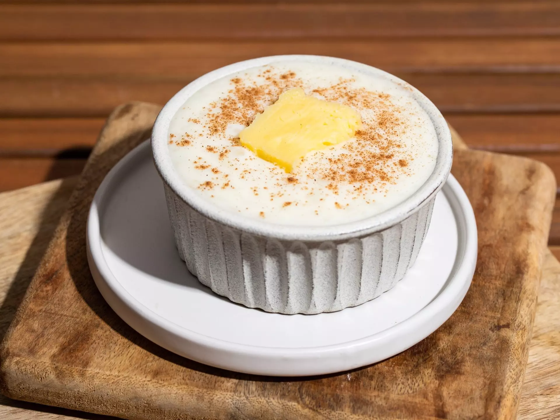 Close up of Risengrod bowl  with butter and cinnamon on wooden table., License Type: media, Download Time: 2025-02-07T14:32:44.000Z, User: meg3348277, Editorial: false, purchase_order: 56530 - Guidebooks, job: Global Publishing-WIP, client: Denmark & the Faroe Islands 10, other: Megan Cassidy