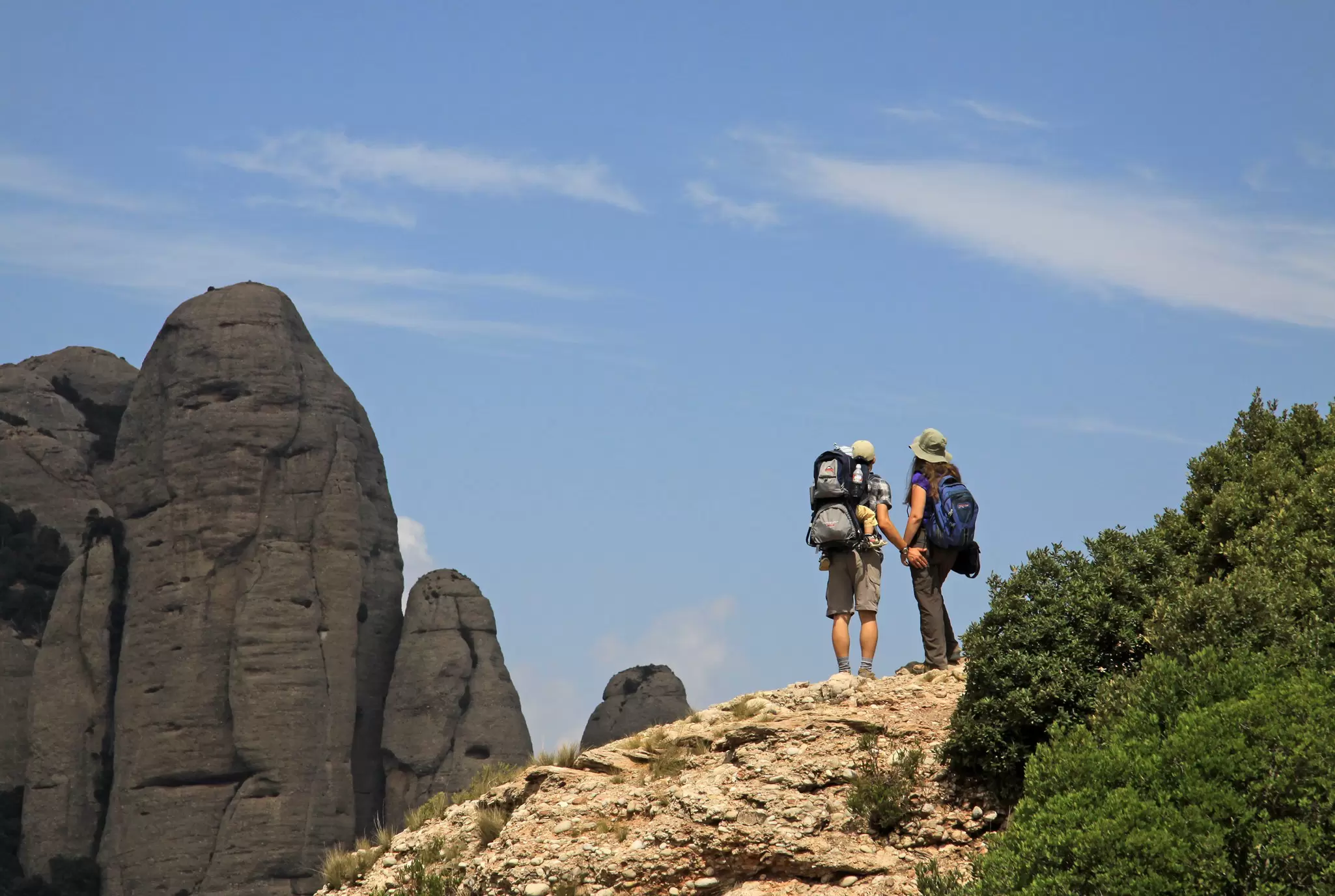 A couple hiking on a path in the mountains near the Monestir de Montserrat near Barcelona, Spain.