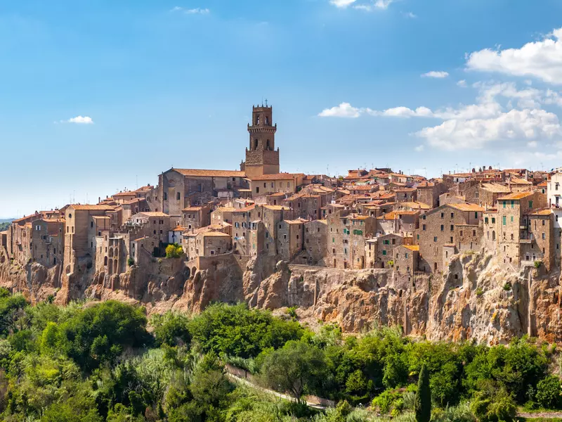 A red-brick Tuscan town built into the side of a ridge. 