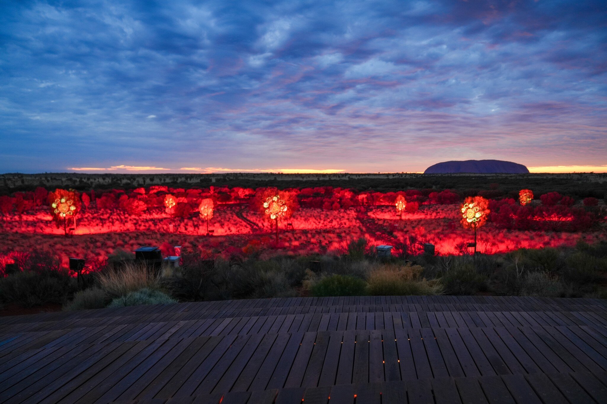 Sunrise Journey in Uluru-Kata Tjuta National Park, Northern Territory, Australia. 5 illuminated foreground creates contrast with the surrounding darkness 