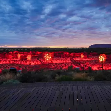 Sunrise Journey in Uluru-Kata Tjuta National Park, Northern Territory, Australia. 5 illuminated foreground creates contrast with the surrounding darkness 