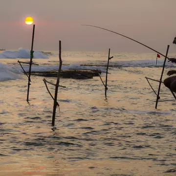 Man fishing from stilt at sunset, Unawatuna, Sri Lanka