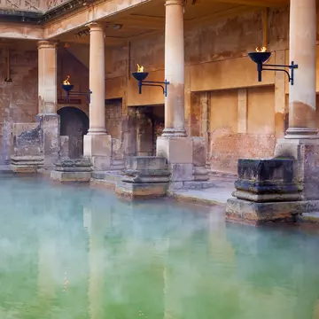 Steam rising off the hot mineral water in the Great Bath, part of the Roman Baths in Bath
