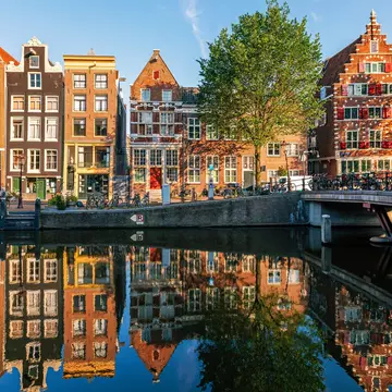 Historic Dutch houses reflected in the canal, Amsterdam. Alexander Spatari/Getty Images