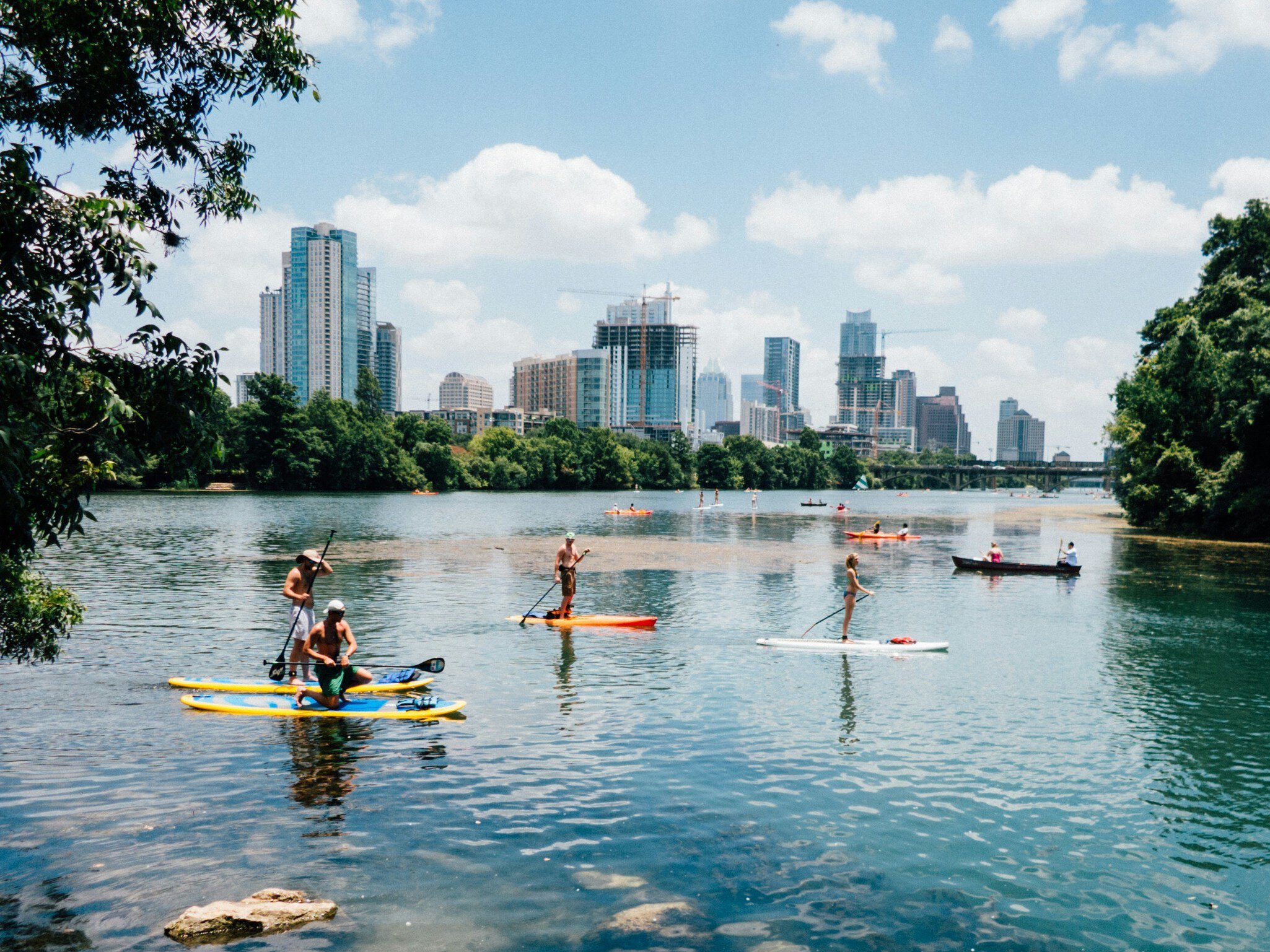 View of the city skyline at sunset across the Lady Bird River in Austin, Texas.