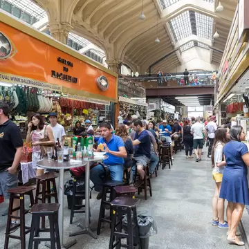 People visiting the famous Municipal Market (Mercado Municipal) in Sao Paulo. Its a huge and bustling market with local fruit, vegetable, spice or condiment you could ask for.
