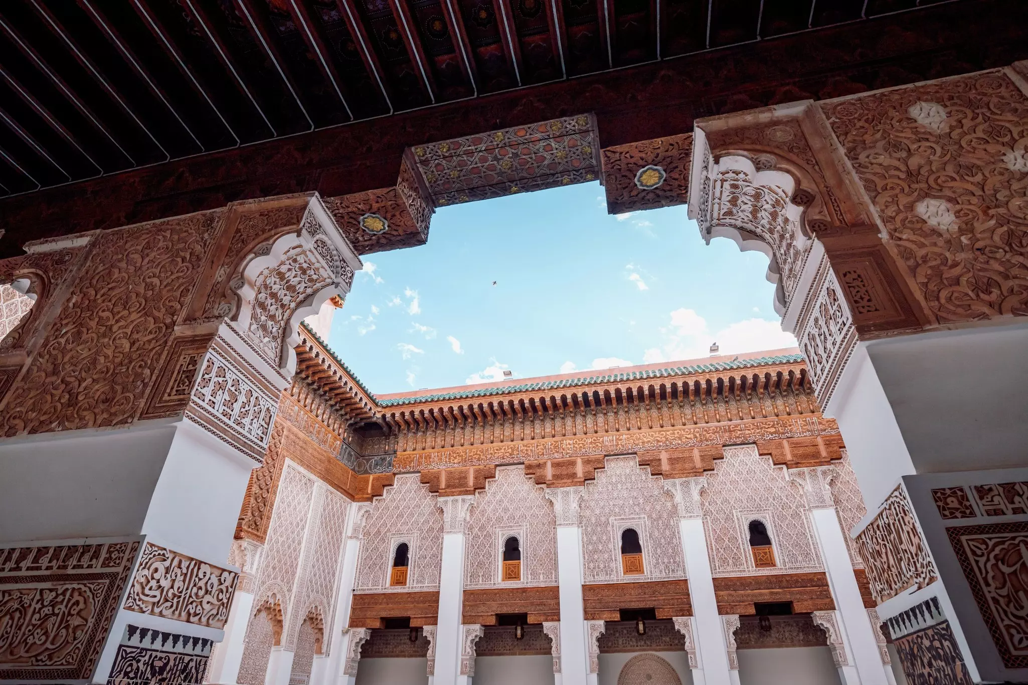 Traditional Moroccan architecture with intricate carvings and geometric patterns at Ben Youssef Medersa, Marrakesh