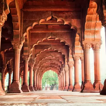 Columns support scalloped arches in a grand pavilion, Diwan-i-Am (Hall of Public Audiences) at the Red Fort in New Delhi, India.
