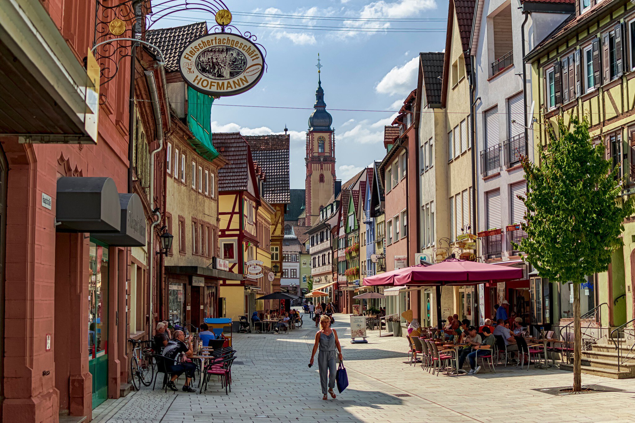 In Tauberbischofsheim, Bavaria, Germany on 08/24/2019. Main street full of establishments in a small town on the Romantic Road.   License Type: media  Download Time: 2023-08-31T01:12:26.000Z  User: mvm_lonelyplanet  Is Editorial: Yes  purchase_order:   