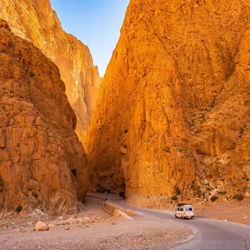 Car driving on narrow scenic road in Dades Gorge canyon with mountains in background, Morocco, North Africa, License Type: media, Download Time: 2025-03-27T20:56:04.000Z, User: dogutierrez_redventures, Editorial: false, purchase_order: 65020 - Marketin...
