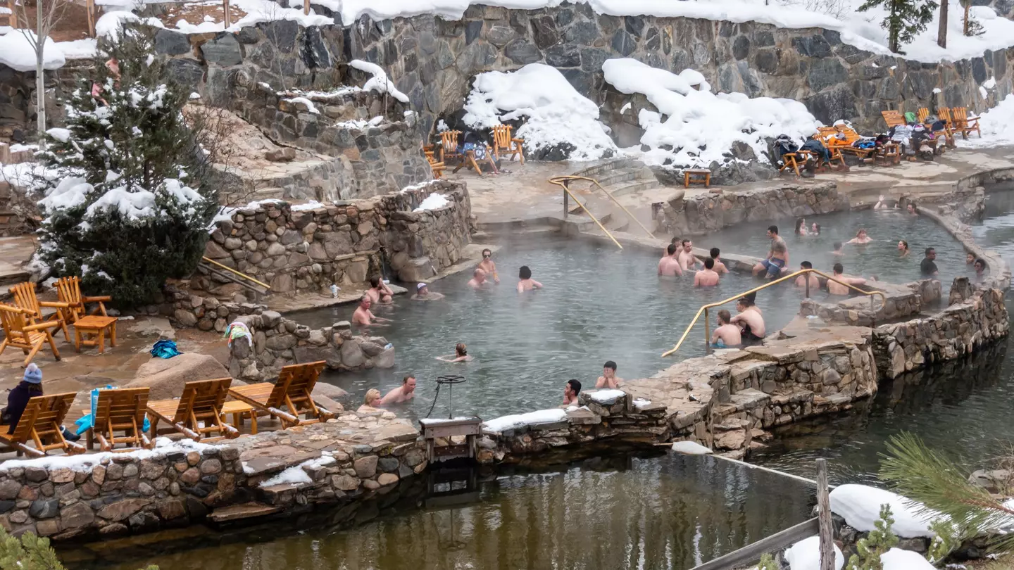 People enjoy the outdoor Strawberry Park Hot Springs.
