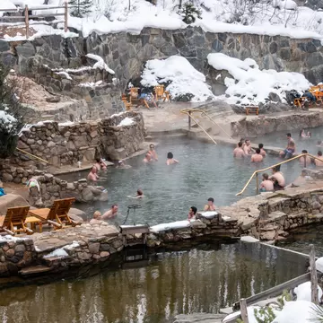 People enjoy the outdoor Strawberry Park Hot Springs.