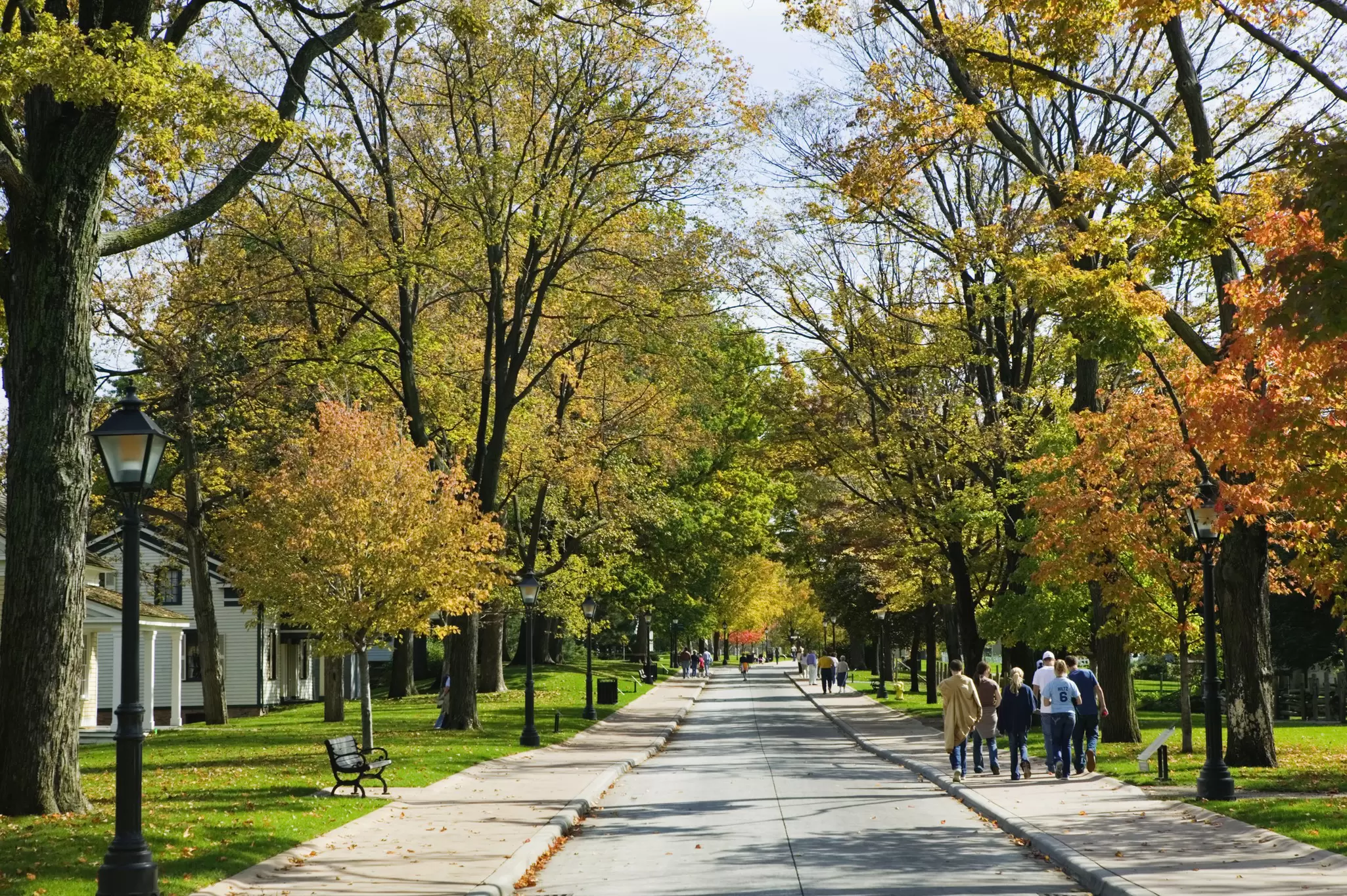 People Strolling on Sidewalk Through Neighborhood