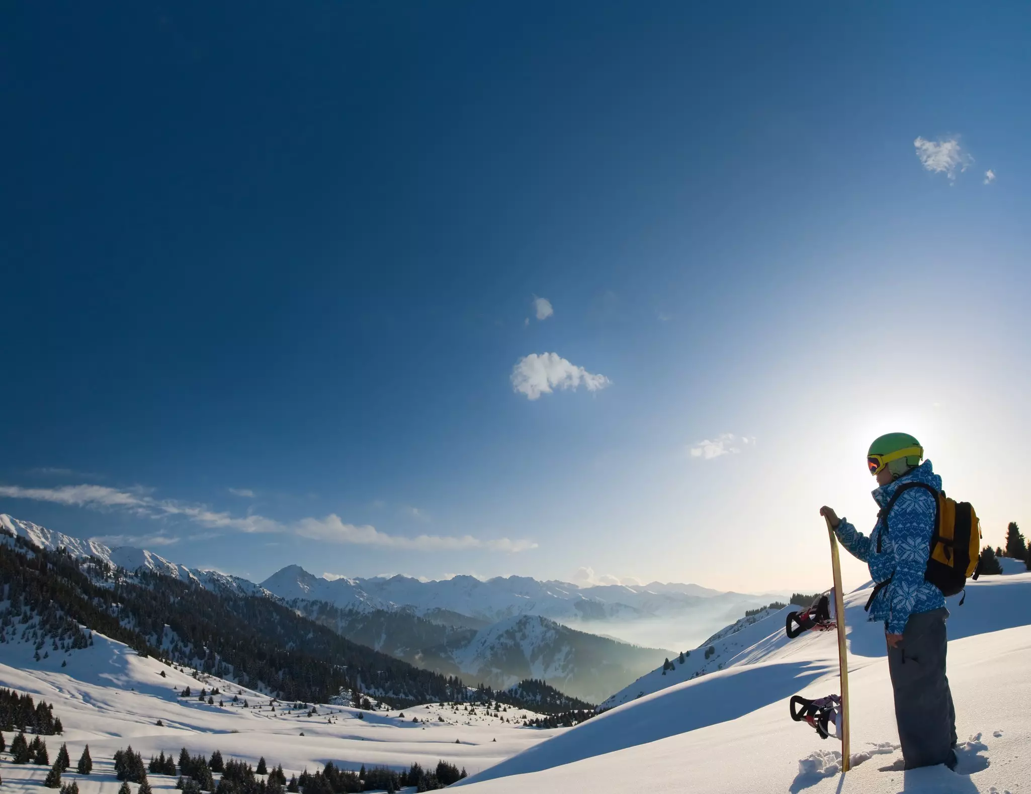 A snowboarder looking onto the mountains around Grindelwald