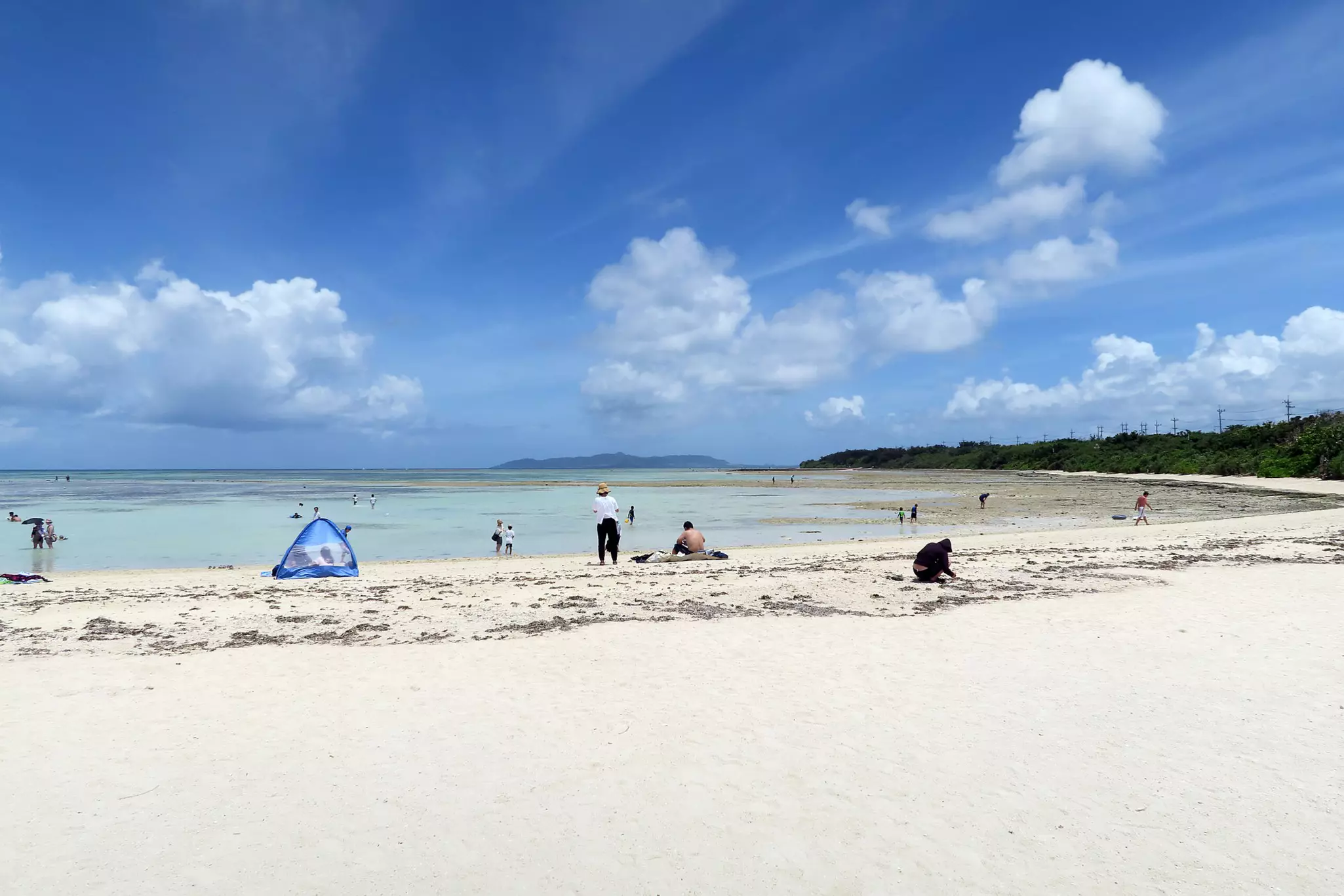 A sparsely populated white-sand beach