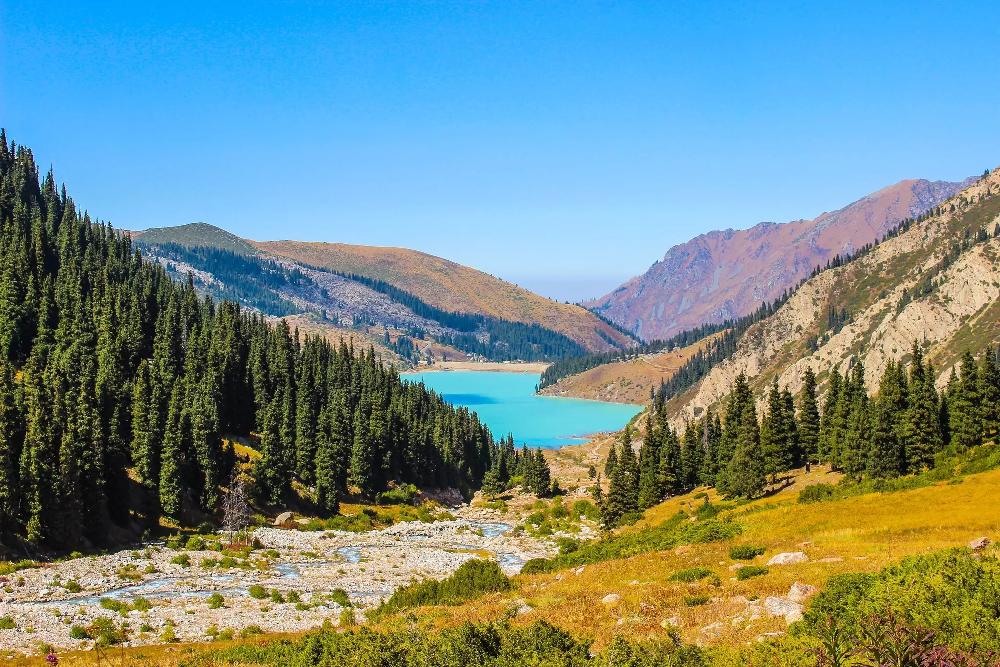 Landscape view of Big Almaty Lake with mountains and turquoise water, Kazakhstan.