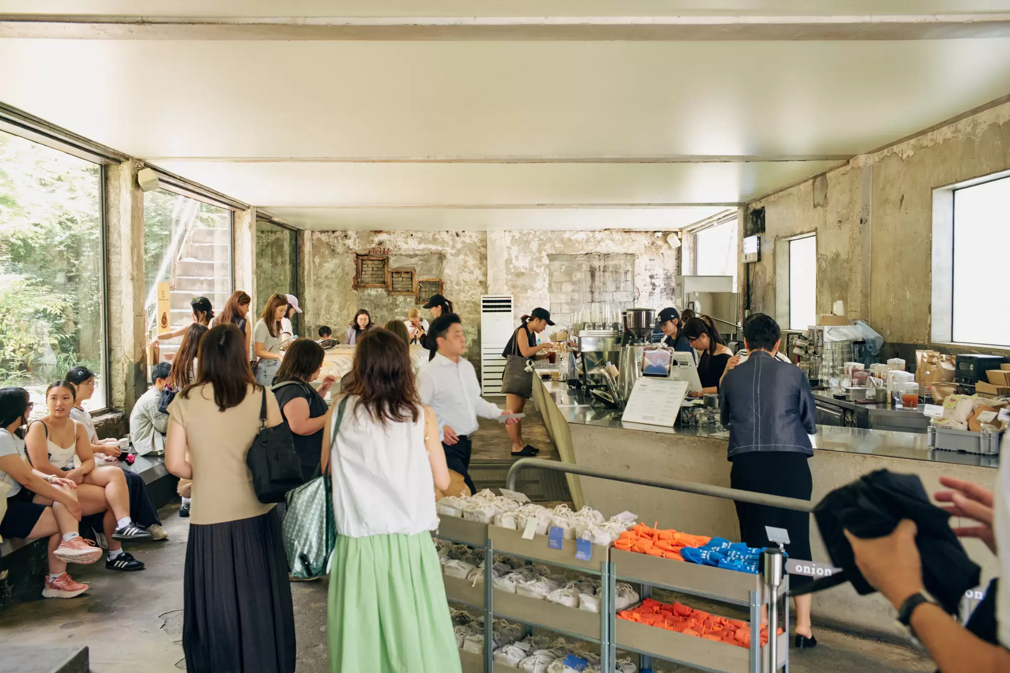 people wait in line to pay at a cafe
