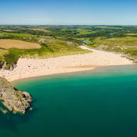 A beautiful sandy beach and rocky coastline. 