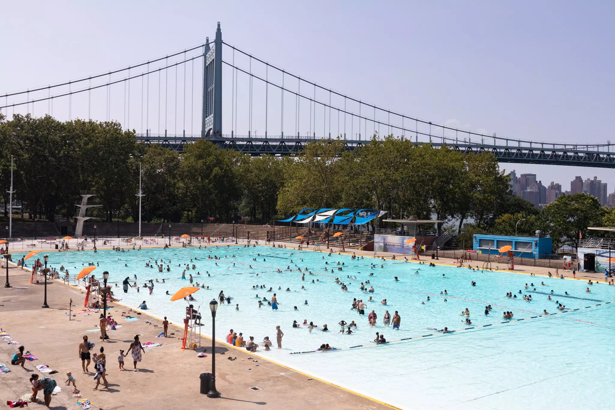 Astoria Queens, New York / USA Astoria Pool at Astoria Park during the Summer with People and the Triborough Bridge in the Background