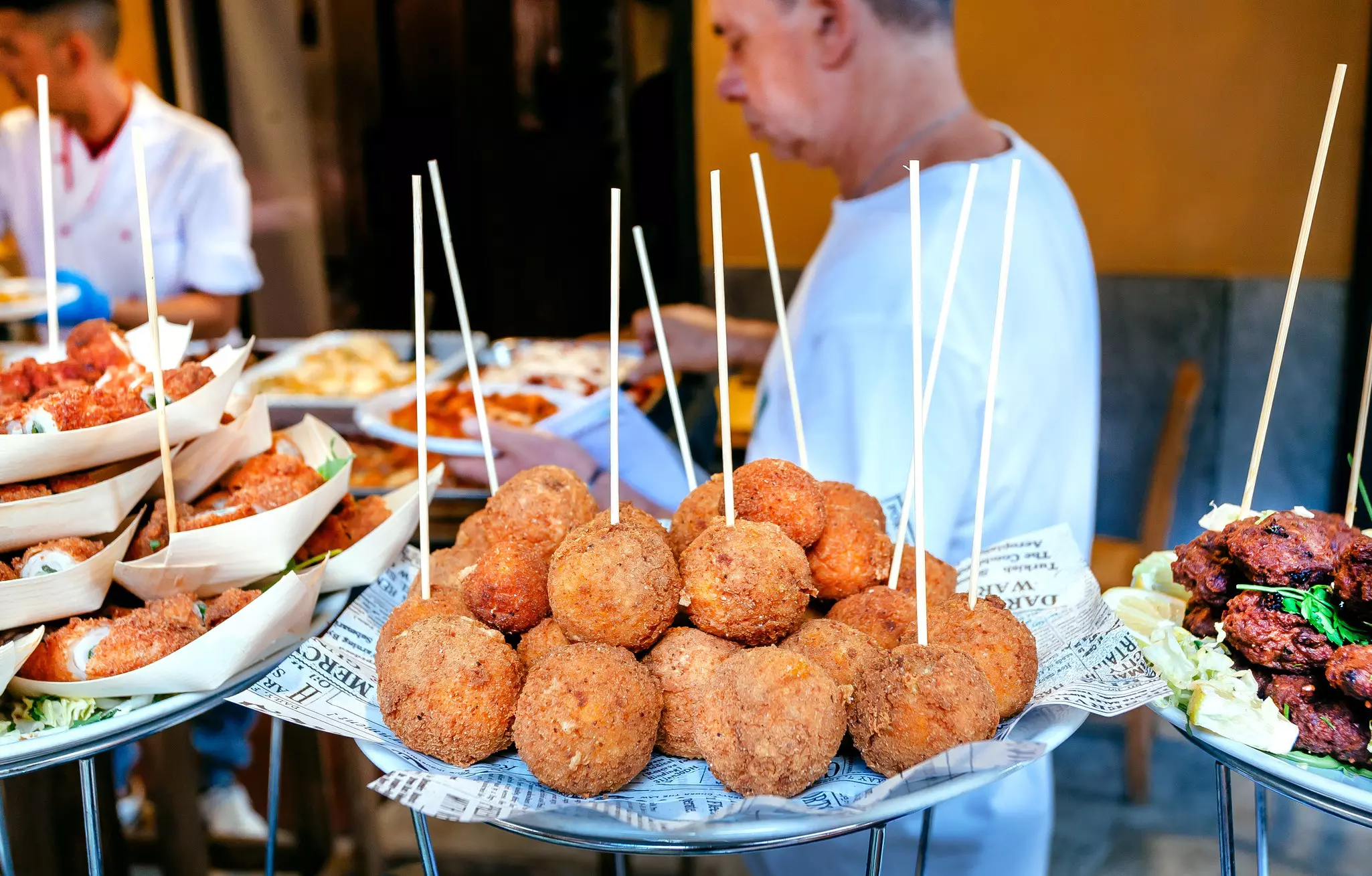 PALERMO, ITALY: Arancini for hungry customers of street market, tasty stuffed rice balls, traditional sicilian snack on 10 October 2019. Sicily is Italian region with highest number of expatriates  License Type: media  Download Time: 2023-07-18T15:47:08.000Z  User: FergalCo  Is Editorial: Yes  purchase_order:   