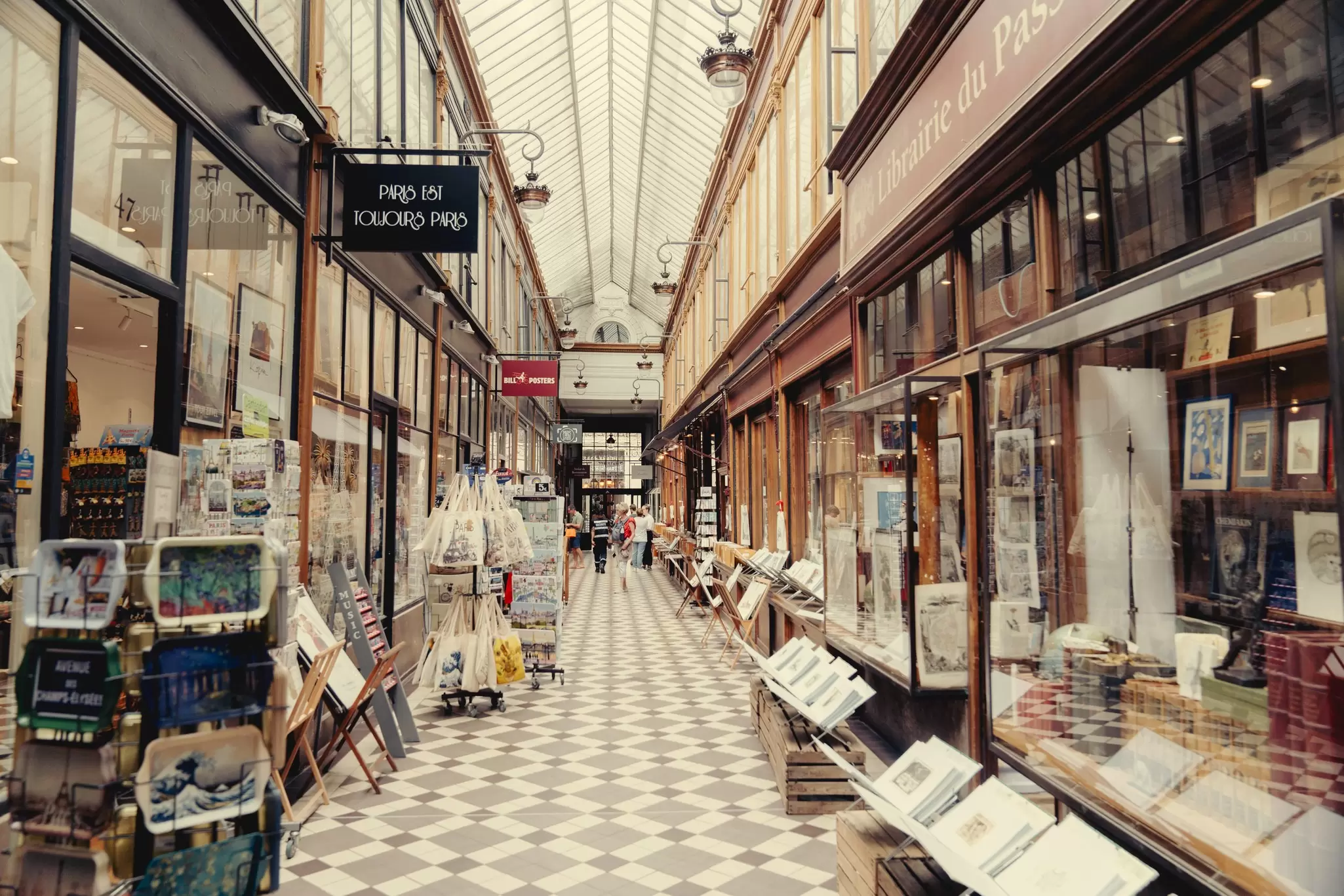 A long indoor passage lined with shops and restaurants