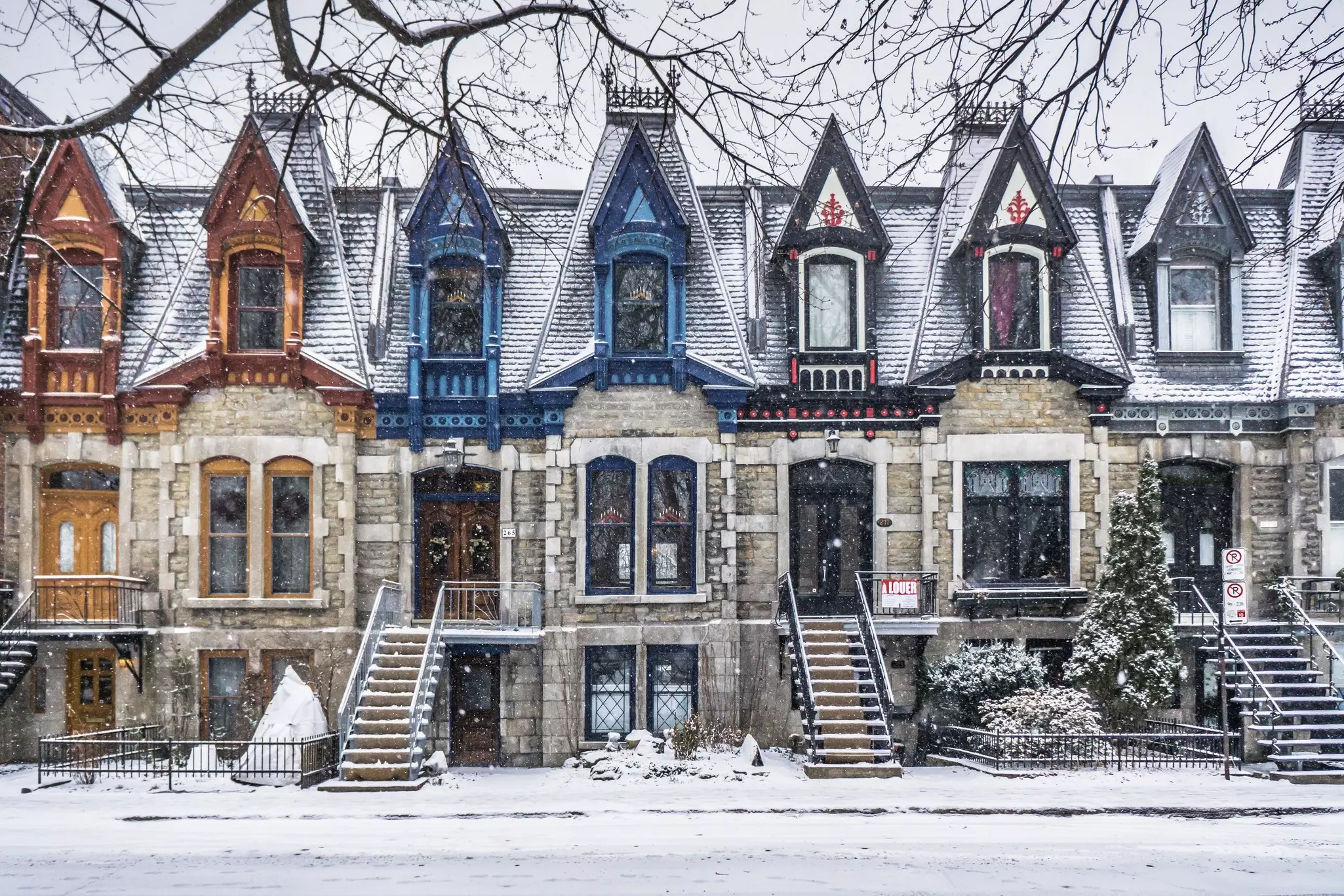 A view of Victorian houses with colorful architectural details on Carré Saint Louis in the Plateau, Montréal, Québec, Canada