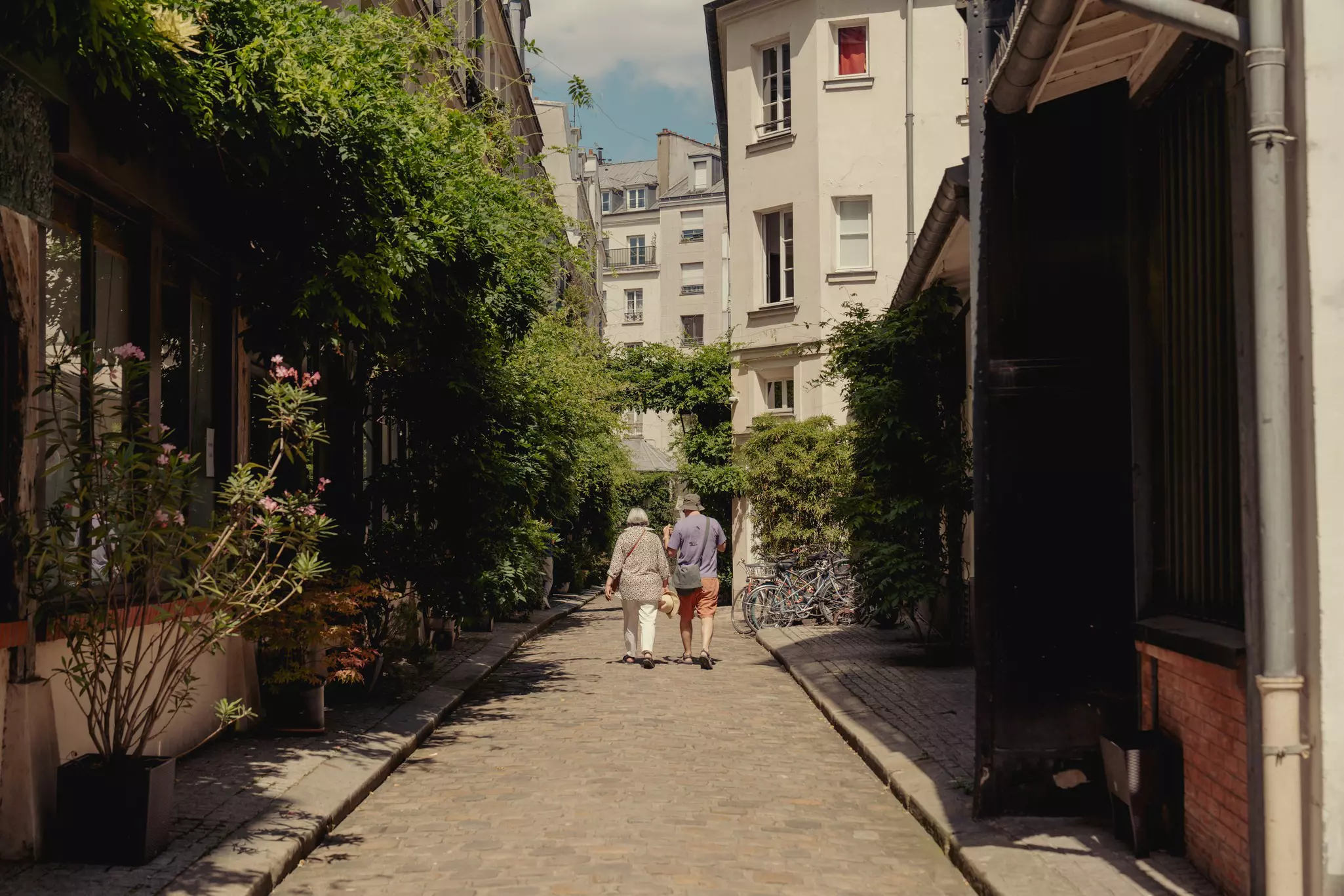 Two people walking along Cour Damoye in Paris, France