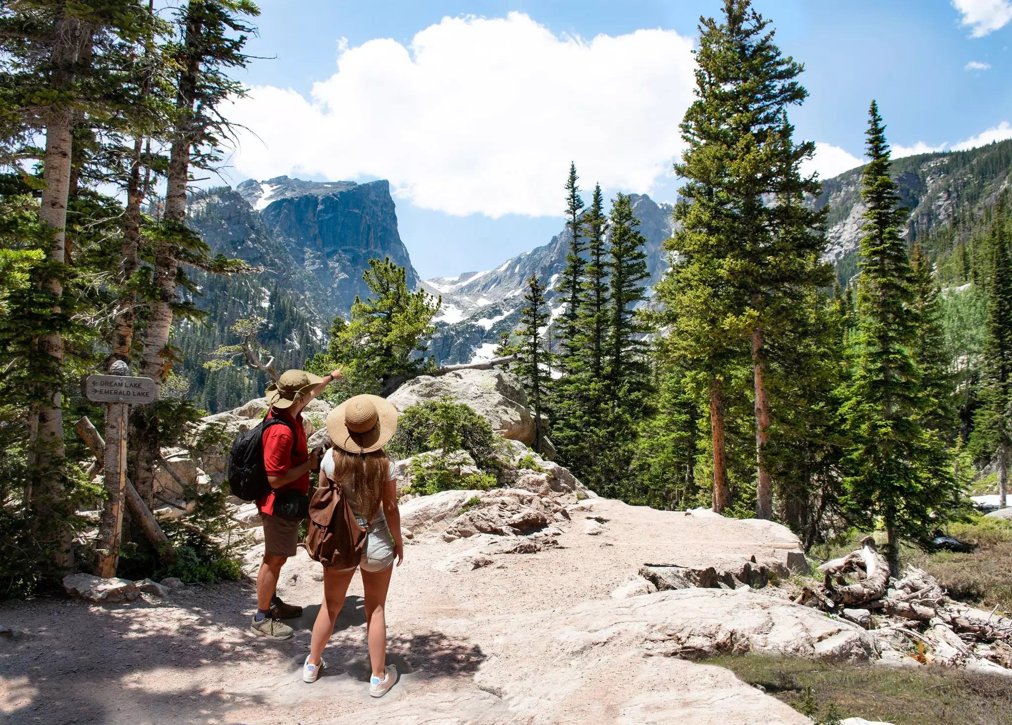 Man and woman with backpacks hiking on Emerald Lake trail